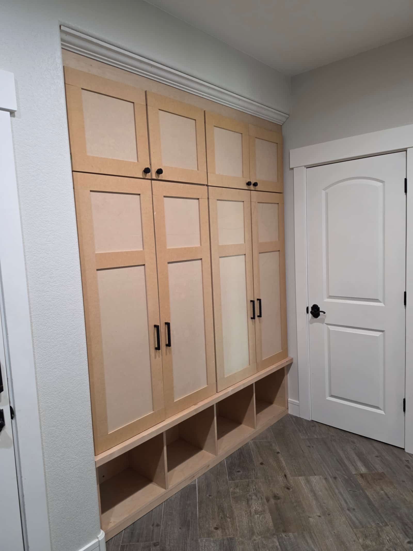 Built-in cabinet run with open shelving and panelled doors, finished and installed
