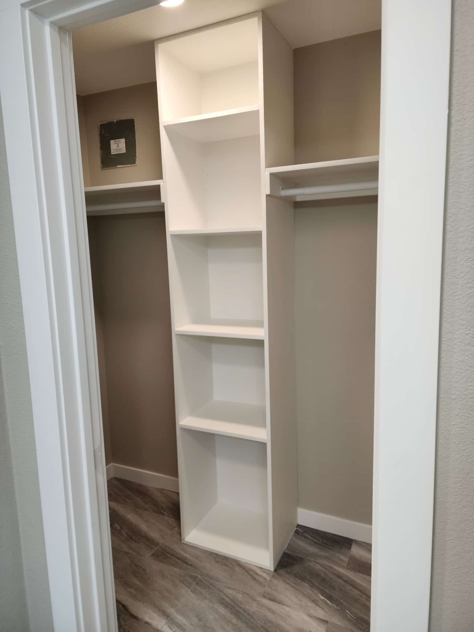 Fitted white storage cupboard with adjustable shelving