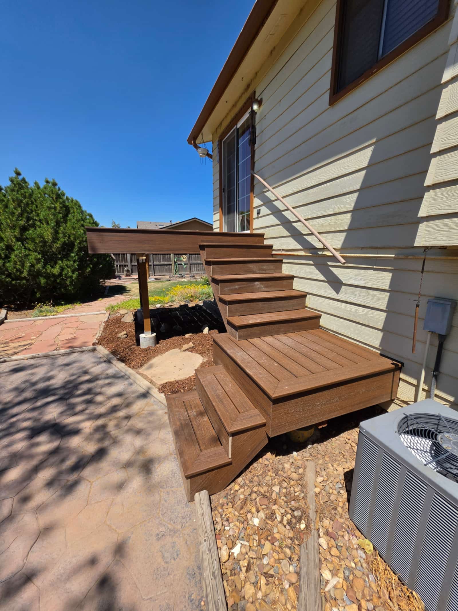 Deck under construction showing the stair stringers and framing before the boards go down
